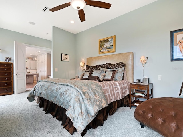 carpeted bedroom with ceiling fan and ensuite bathroom