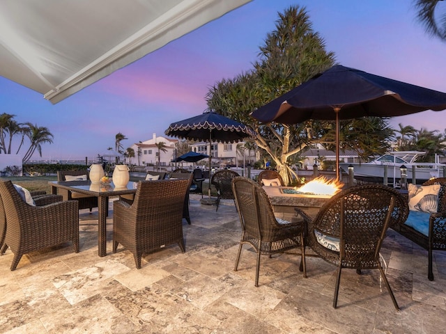 patio terrace at dusk with an outdoor fire pit