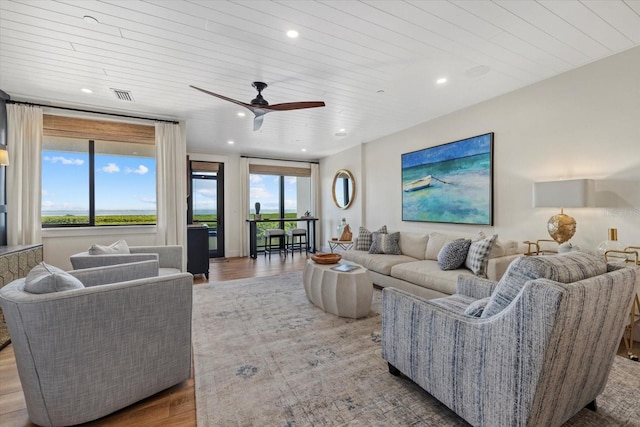 living room featuring hardwood / wood-style floors, ceiling fan, and wood ceiling