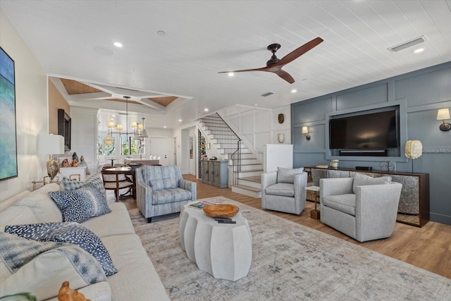 living room with light hardwood / wood-style floors, ceiling fan, and wooden ceiling