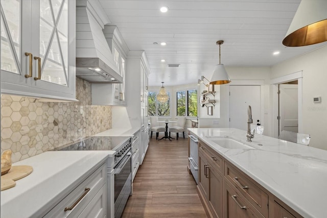 kitchen featuring white cabinets, decorative light fixtures, decorative backsplash, and appliances with stainless steel finishes