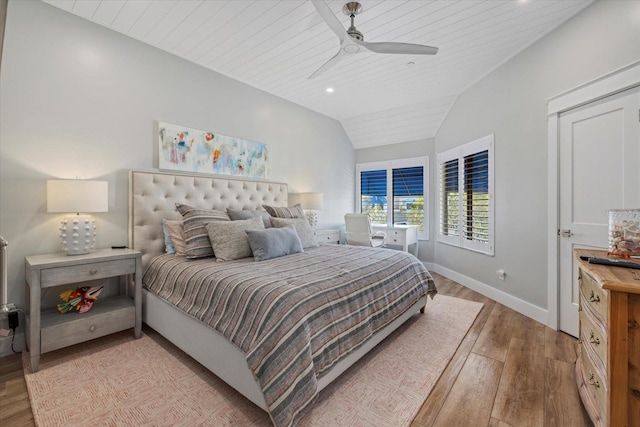 bedroom with ceiling fan, light hardwood / wood-style flooring, wooden ceiling, and vaulted ceiling