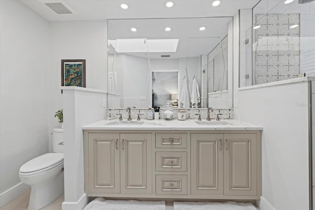 bathroom with toilet, an enclosed shower, and vanity