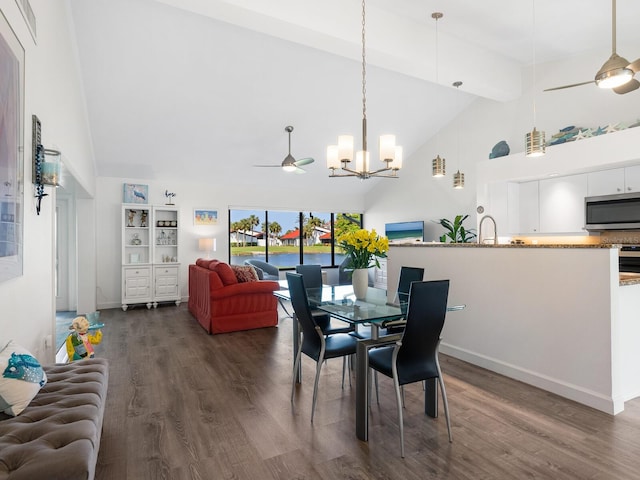 dining room featuring ceiling fan with notable chandelier, high vaulted ceiling, and dark hardwood / wood-style flooring