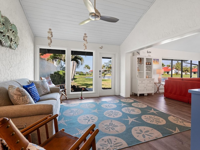 living room featuring ceiling fan, dark wood-type flooring, wooden ceiling, and lofted ceiling