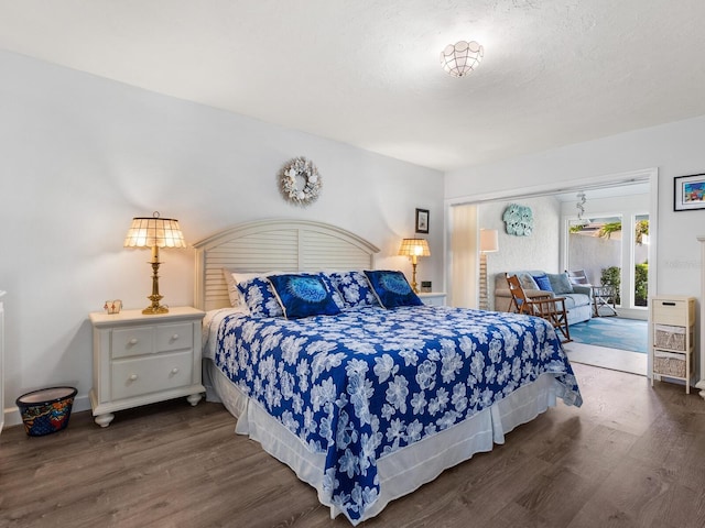 bedroom with dark hardwood / wood-style floors