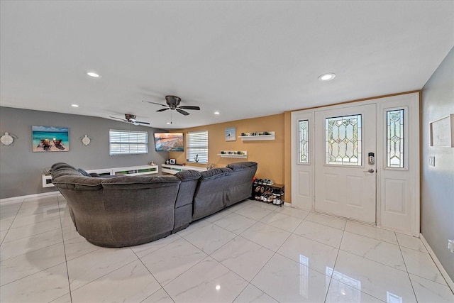 living room with plenty of natural light and ceiling fan