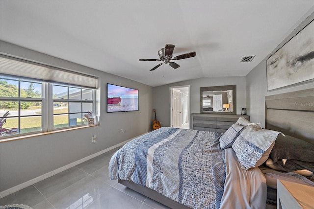 tiled bedroom with vaulted ceiling and ceiling fan