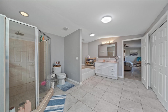 full bathroom with tile patterned floors, vanity, vaulted ceiling, shower with separate bathtub, and toilet