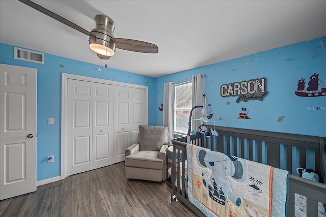 bedroom with ceiling fan, dark hardwood / wood-style floors, and a closet