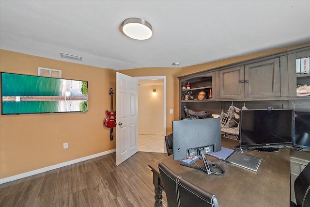 home office with hardwood / wood-style flooring