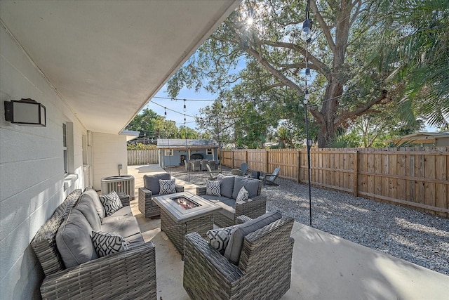 view of patio / terrace with exterior bar, central AC, and an outdoor living space with a fire pit