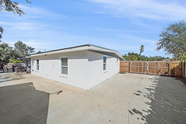 view of side of home featuring a patio area