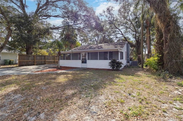 ranch-style home with a front yard and a sunroom