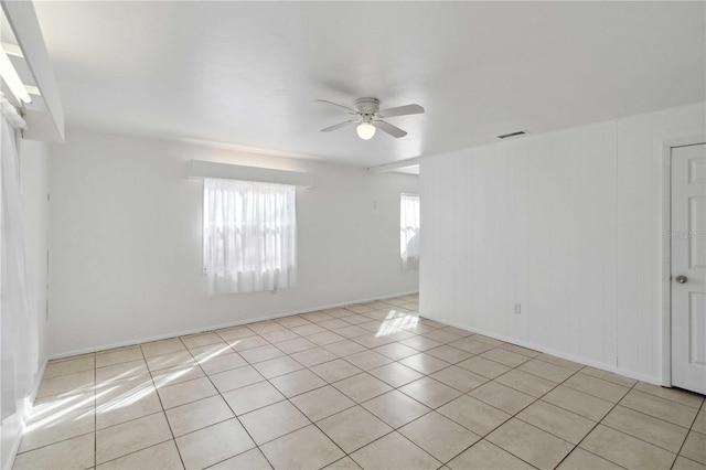 unfurnished room featuring light tile patterned floors and ceiling fan