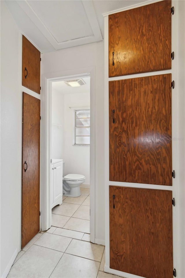 bathroom featuring toilet and tile patterned flooring