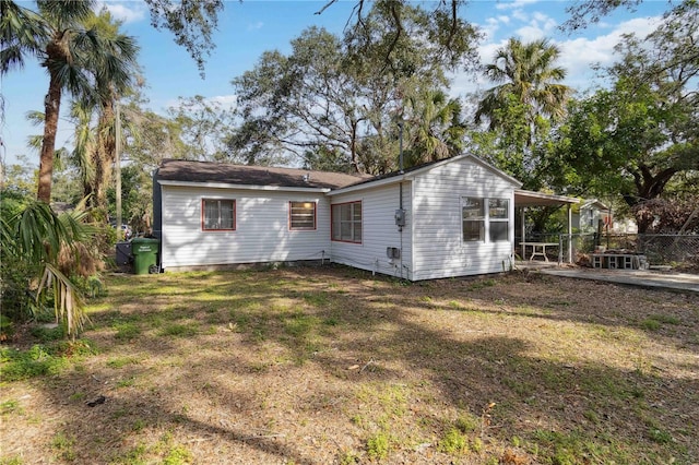 rear view of property with a yard