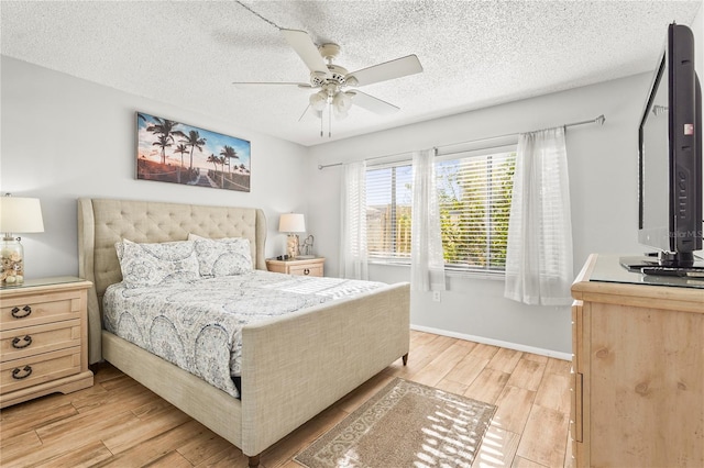 bedroom with a textured ceiling and ceiling fan