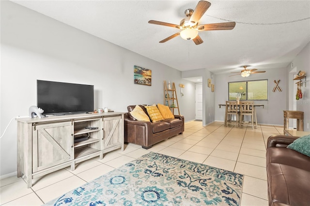 living room featuring a textured ceiling, a ceiling fan, and tile patterned floors