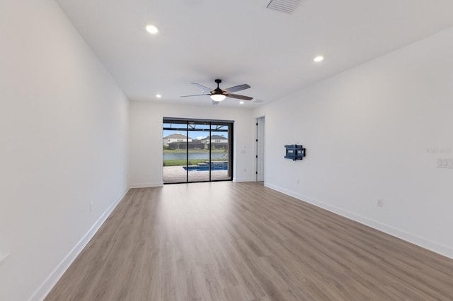 spare room with ceiling fan and light hardwood / wood-style flooring