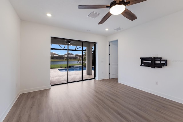 spare room featuring hardwood / wood-style flooring and ceiling fan