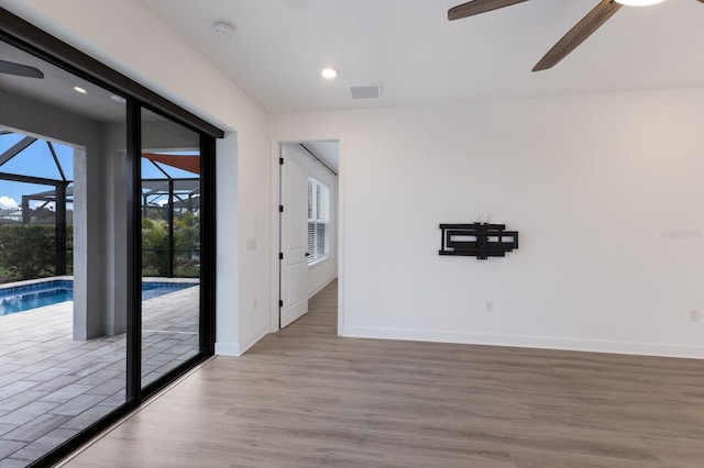 unfurnished room featuring ceiling fan and light wood-type flooring