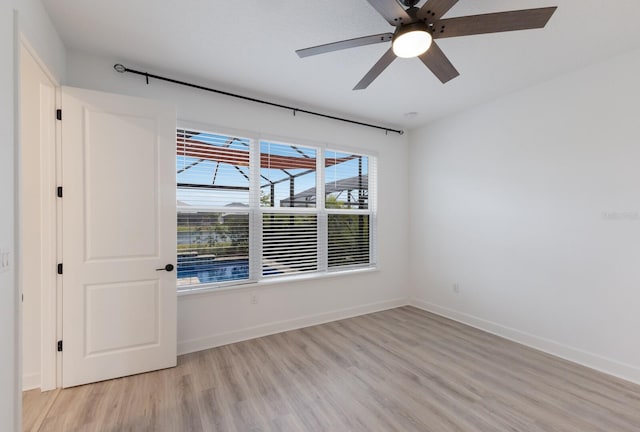 spare room featuring light hardwood / wood-style flooring and ceiling fan