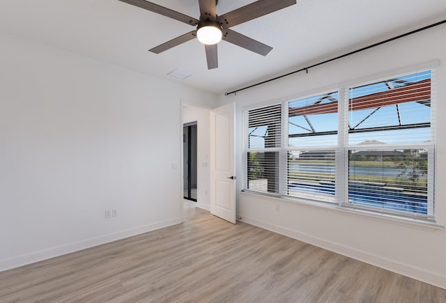 unfurnished room with ceiling fan and light wood-type flooring