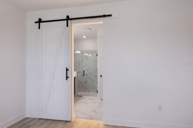 bathroom featuring hardwood / wood-style floors and a shower with shower door