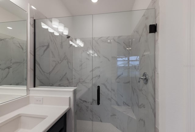 bathroom featuring walk in shower and vanity