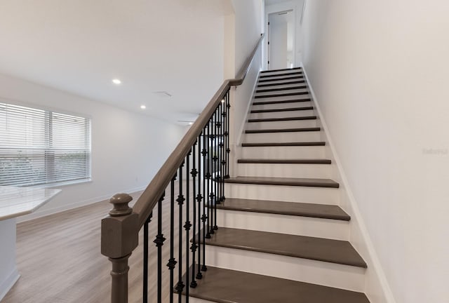 staircase featuring hardwood / wood-style flooring