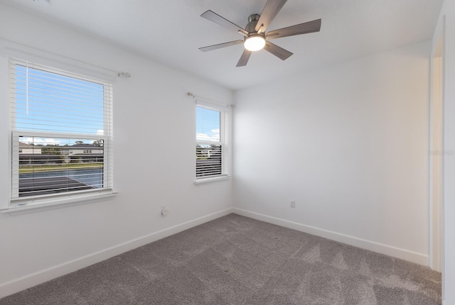 spare room featuring carpet floors and ceiling fan