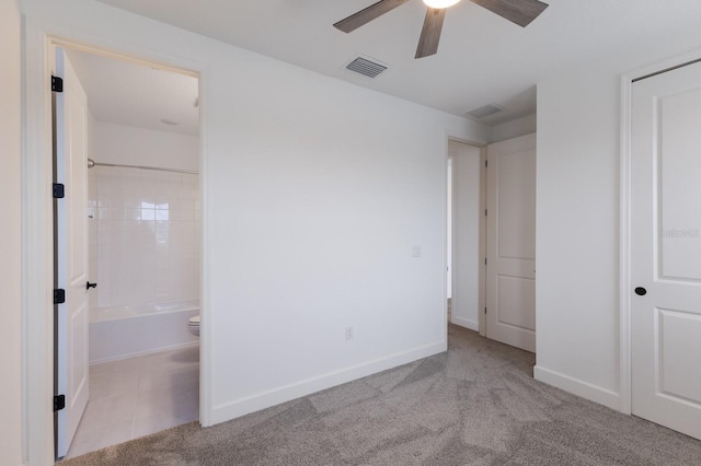 unfurnished bedroom with light carpet, ceiling fan, and ensuite bathroom