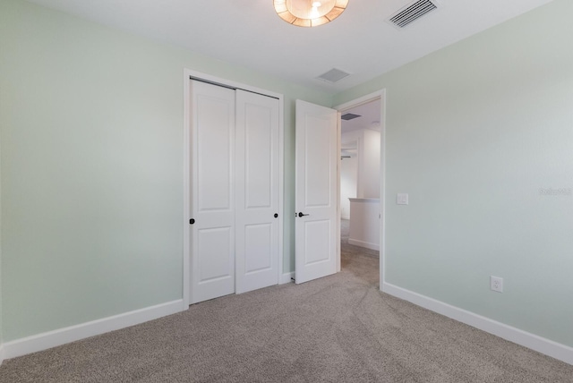 unfurnished bedroom featuring a closet and carpet