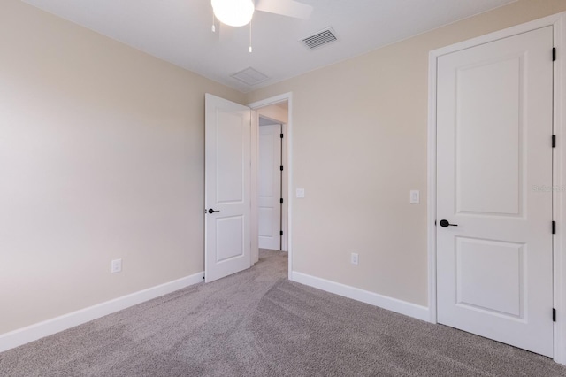 unfurnished bedroom with light colored carpet and ceiling fan