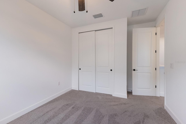 unfurnished bedroom featuring ceiling fan, carpet floors, and a closet