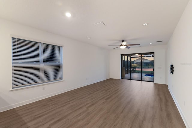 spare room with ceiling fan and dark hardwood / wood-style flooring