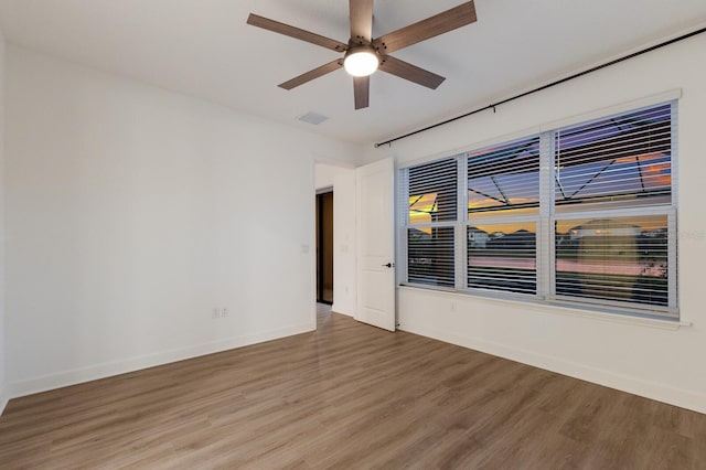 spare room featuring hardwood / wood-style flooring and ceiling fan