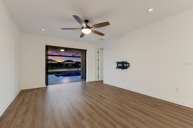 unfurnished room with hardwood / wood-style floors and ceiling fan