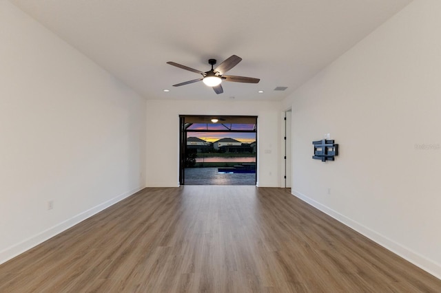 empty room featuring hardwood / wood-style flooring and ceiling fan