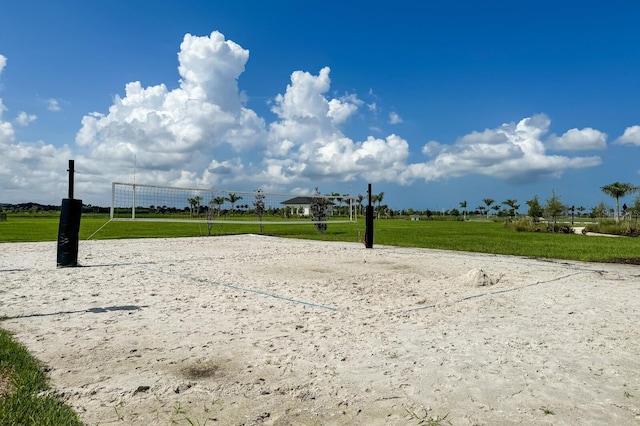 view of home's community featuring a lawn and volleyball court