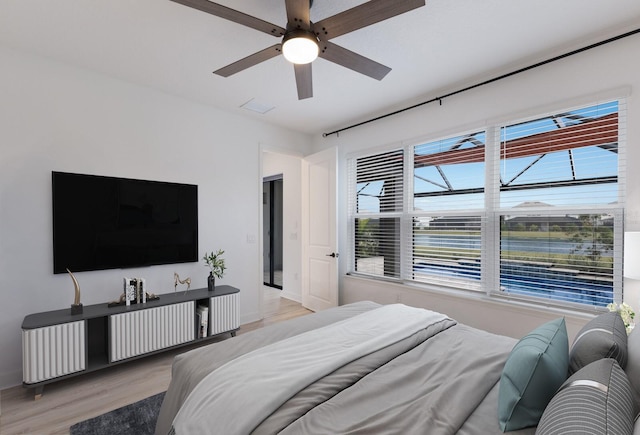 bedroom with light hardwood / wood-style floors and ceiling fan