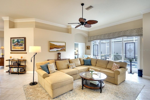 tiled living room with ceiling fan and crown molding