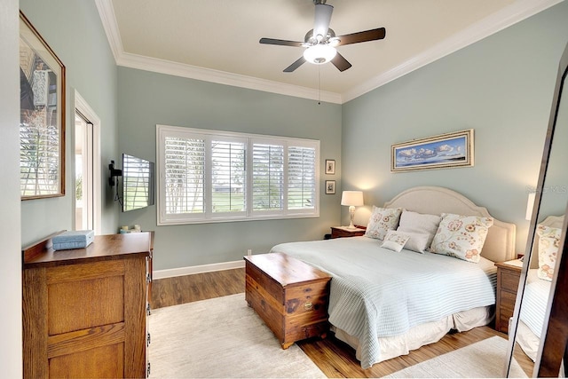 bedroom with light hardwood / wood-style floors, ceiling fan, and ornamental molding