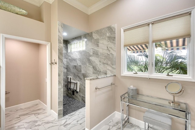 bathroom with tiled shower, a wealth of natural light, and ornamental molding