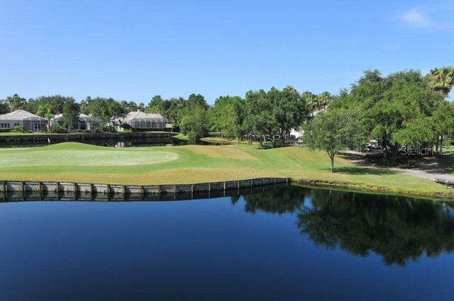 surrounding community featuring a lawn and a water view