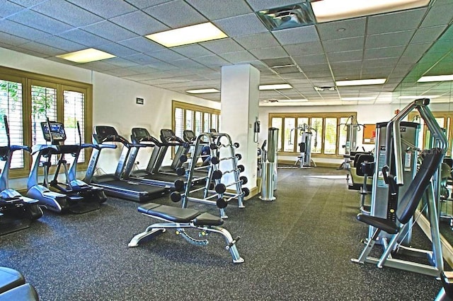 gym with a paneled ceiling and plenty of natural light