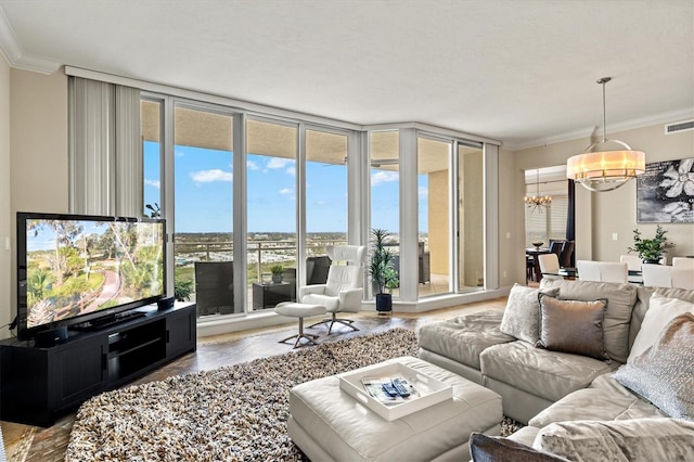 living room with visible vents, floor to ceiling windows, crown molding, and a notable chandelier