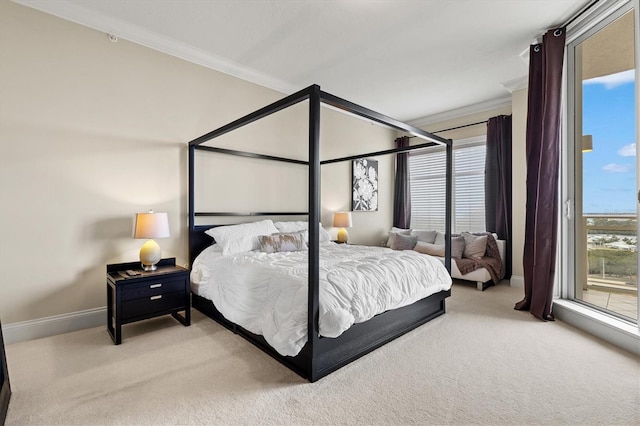 carpeted bedroom with ornamental molding and baseboards