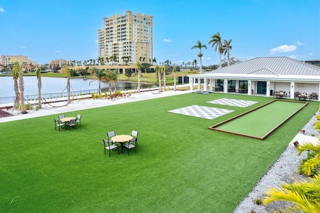 surrounding community featuring a water view and a yard